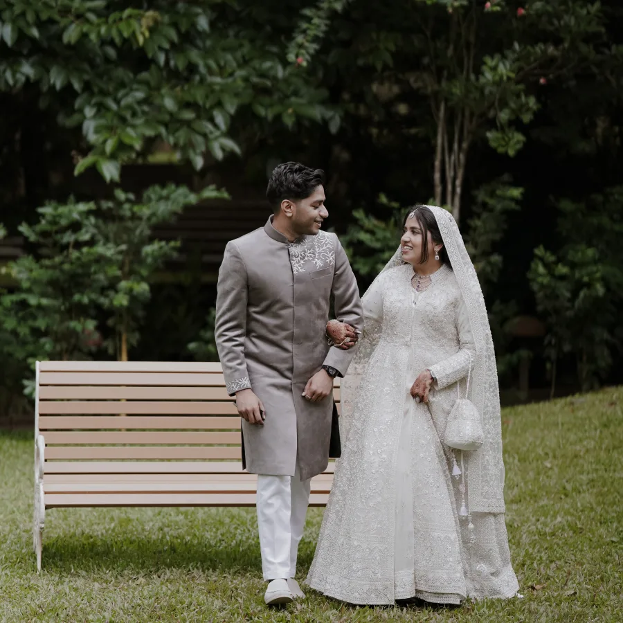 Murshida and Ashique together beside a garden bench
